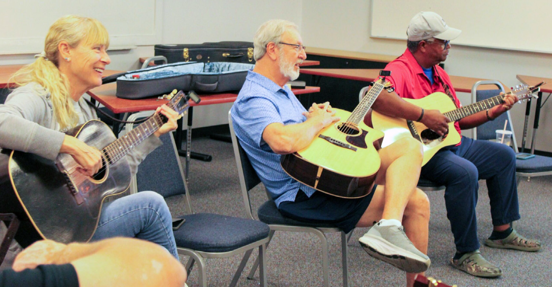 OLLI guitar club students practice chords.